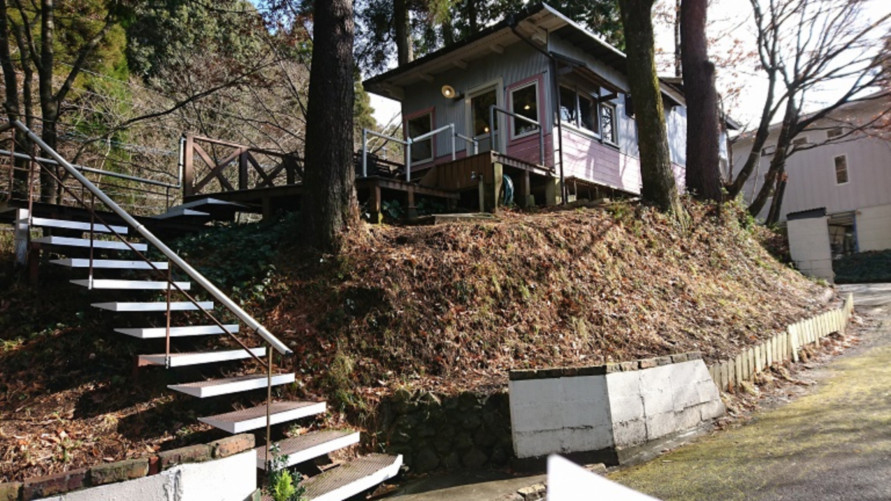 階段を上った先に建つ白い建物。平成8年（1996）にオープンした。お店の裏手では燻製したベーコンもパンに使用している。