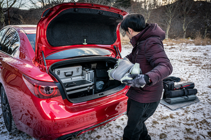 日産・スカイライン400Rのトランクに天体望遠鏡をしまう田畑さん