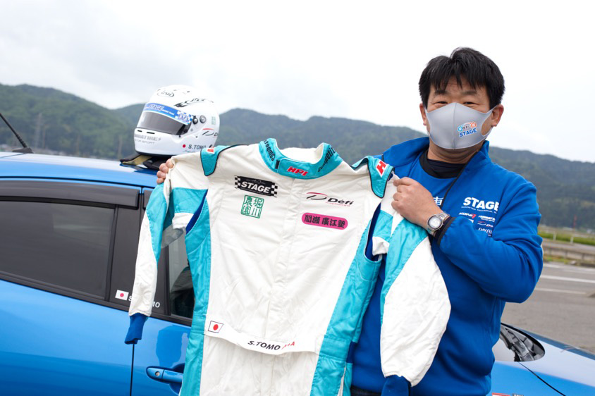 マツダ・デミオ15MBのオーナー坂井さんとレーシングスーツ