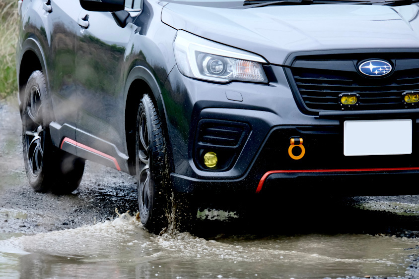 水たまりを走るスバル・フォレスターX-BREAK
