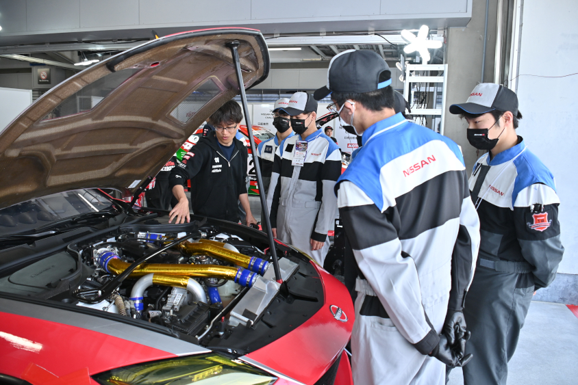 日産メカニックチャレンジに参加している学生からの質問にチームのメカニックも実物を前にしてしっかりレクチャーする